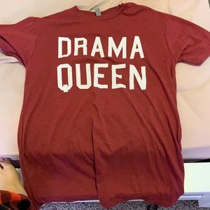 A small maroon dram queen shirt.
